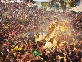  ?? — PTI ?? Devotees take part in a religious procession of ‘ Lord Kallazhaga­r’ during Chithirai festival in Madurai on Monday.