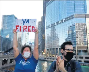  ?? CHRIS SWEDA/CHICAGO TRIBUNE ?? With Trump Tower in the background, people celebrate in Chicago after Joe Biden defeated President Donald Trump in the election.