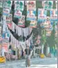  ?? REUTERS ?? A man rides a cycle past the election posters in Quezon city, Metro Manila.