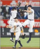  ?? The Associated Press ?? New York Yankees’ Starlin Castro, upper left, and Aaron Judge, right, celebrate in a leap behind Brett Gardner after beating the Minnesota Twins 2-1 on Monday.