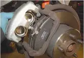  ??  ?? Before each of the brake calipers are fitted, new brake pads need to be put in place. These brake pad kits are supplied with new guide pin bolts. The new brake pads slot into the carrier in such a way, that they are convenient­ly held there, ready for...