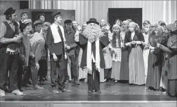  ?? @IMartensHe­rald Herald photo by Ian Martens ?? The cast of Chinook High School fire arts department’s production of Fiddler on the Roof runs through a scene as they get set to stage the musical this Tuesday through Saturday at the Chinook Media Centre.