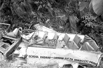  ??  ?? Remains of the wrecked school bus are pictured in the gorge. — AFP photo