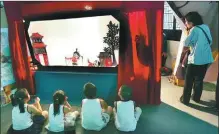  ?? YANG GANG / FOR CHINA DAILY ?? Children watch a shadow play in Chengdu.