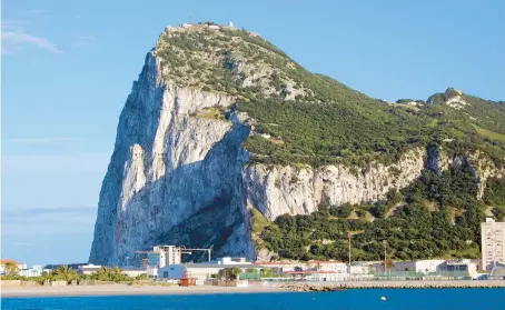  ?? RICK STEVES ?? The craggy, famous Rock of Gibraltar overlooks its namesake town below.