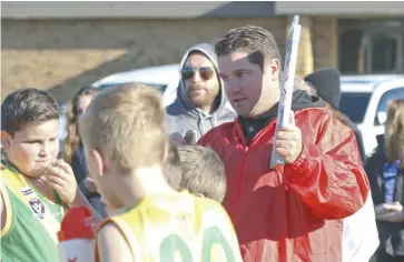  ??  ?? Garfield Stars under 12s coach Tate Burgmann asks his players to continue to run and chase at three-quarter-time.