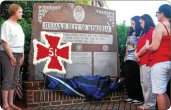  ??  ?? David Wintz’s name is unveiled on a monument memorializ­ing the town’s fallen first responders.