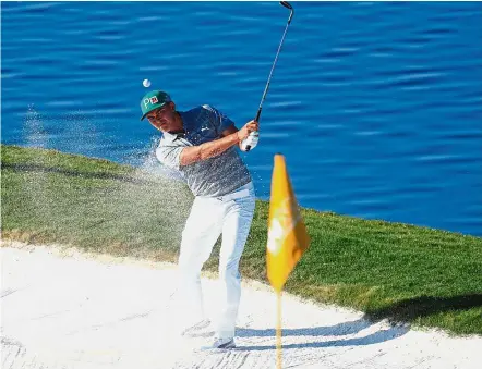  ?? — Reuters ?? Off it goes: Rickie Fowler hitting a shot from the bunker on the 15th hole during the third round of the Phoenix Open at TPC Scottsdale on Saturday.