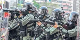  ??  ?? Riot police prepare to fire tear gas during a protest in the Mong Kok district of Hong Kong.
BLOOMBERG/FILE