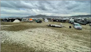  ?? JULIE JAMMOT/AFP VIA GETTY IMAGES/TNS ?? Camps are set on a muddy desert plain on Sept. 2, 2023, after heavy rains turned the annual Burning Man festival site in Nevada’s Black Rock desert into a mud pit.