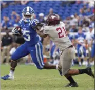  ?? BEN MCKEOWN - THE ASSOCIATED PRESS ?? Duke’s Deon Jackson (25) shoves away North Carolina Central’s Daryl Smith (21)during the second half of an NCAA college football game in Durham, N.C., Saturday, Sept. 22, 2018. Duke defeated North Carolina Central 55-13.