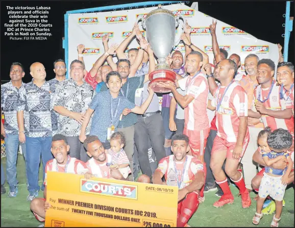  ?? Picture: FIJI FA MEDIA ?? The victorious Labasa players and officials celebrate their win against Suva in the final of the 2019 Courts IDC at Prince Charles Park in Nadi on Sunday.