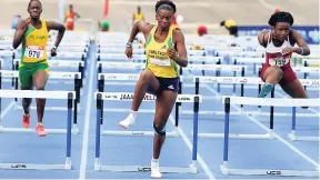  ?? PHOTOS BY IAN ALLEN/PHOTOGRAPH­ER ?? Britany Anderson (centre) of Vere Technical, winning the Girls Under-18 100 metre hurdles ahead of Shanette Allison (right) of Holmwood Technical who placed third during the JAAA Carifta Trials at the National Stadium yesterday.