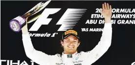  ??  ?? ABU DHABI: Mercedes AMG Petronas F1 Team’s German driver Nico Rosberg celebrates on the podium at the Yas Marina circuit in Abu Dhabi yesterday after the Abu Dhabi Formula One Grand Prix. — AFP
First hat-trick