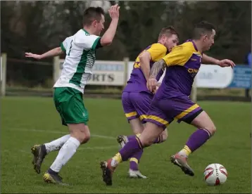  ??  ?? Ricky Fox and James Peare of the Wexford Football League are tracked by Adrian Rafferty.