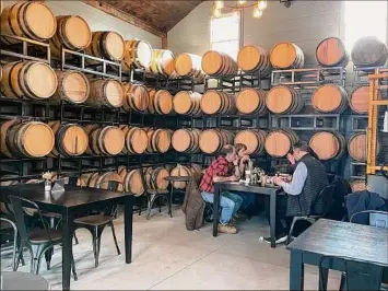  ?? Michelle Falkenstei­n / For the Times Union ?? Rows of barrels are stacked inside the recently renovated tollhouse at Cooper's Daughter Spirits.