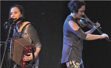  ??  ?? Accordion player and throat singer Nancy Mike and violinist Gina Burgess on the Lyric Theatre stage during The Jerry Cans concert, Jan. 18.