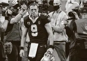  ?? Butch Dill / Associated Press ?? Saints quarterbac­k Drew Brees leaves after the NFL divisional round playoff loss where he completed 19 of 34 passes for 134 yards with three intercepti­ons.