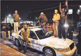  ?? Wally Skalij Los Angeles Times ?? PROTESTERS in front of City Hall in Ferguson, Mo., last year. Protests broke out after a grand jury declined to indict an officer in Michael Brown’s death.