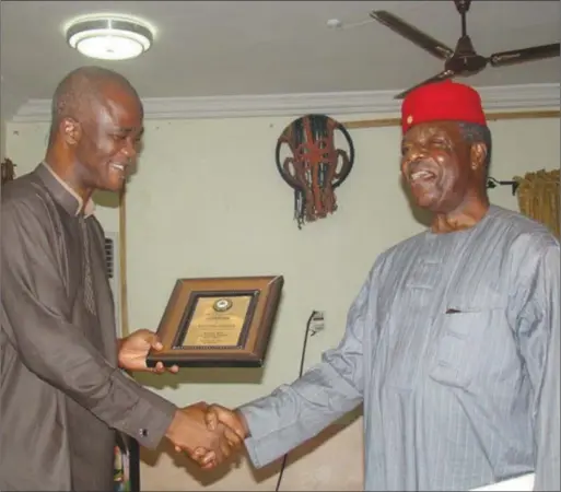  ??  ?? Prof. Ben Obumselu (right) receives his ward from the Chairman, Dr. Obiogbolu