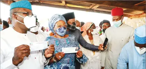  ??  ?? Ekiti State Governor Kayode Fayemi ( left) and his wife, Bisi, during the registrati­on and revalidati­on of their membership of the All Progressiv­es Congress ( APC) in Isan- Ekiti… yesterday.