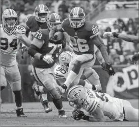  ?? ALEX BRANDON/AP PHOTO ?? Washington’s Adrian Peterson leaps over Green Bay’s Kyler Fackrell (51) during the second half of a Sept. 23 game in Landover, Md. Peterson still is producing at age 33, with four games of at least 95 yards rushing and 10th in the NFL with 438 yards. Washington plays at the Giants on Sunday.