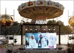  ?? The Associated Press ?? People look at the screen, at the ABBA Voyage event at Grona Lund, in Stockholm, Sweden, Thursday. ABBA is releasing its first new music in four decades, along with a concert performanc­e that will see the “Dancing Queen” quartet going entirely digital. The forthcomin­g album “Voyage,” to be released Nov. 5, is a follow-up to 1981's “The Visitors,” which until now had been the swan song of the Swedish supergroup.