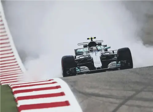  ??  ?? Smoke pours from the back of Valtteri Bottas’ Mercedes during a practice session dominated by Lewis Hamilton yesterday.