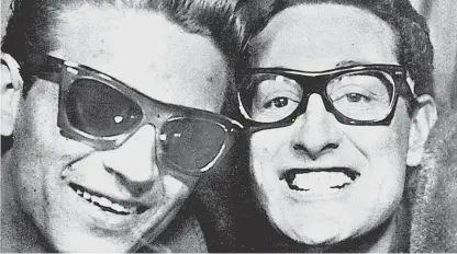  ?? SUN-TIMES FILES ?? Future country star Waylon Jennings (left) and rock icon Buddy Holly in a photo booth in 1959. A month before the “Winter Dance Party” tour began, Holly asked his friend Jennings to learn the bass guitar so he could join the band.