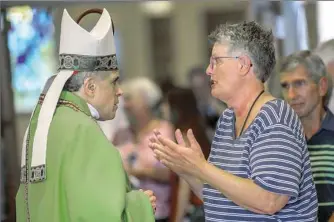  ??  ?? Cardinal Daniel N. DiNardo, president of the U.S. Conference of Catholic Bishops, left, speaks with Marian Ferrar, of Hampton, after vocation Mass on Saturday.