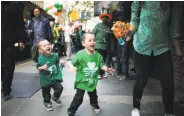  ?? Mason Trinca / Special to The Chronicle 2017 ?? Pilar Manning blows bubbles for her sons, Tanner, 4, and Sawyer, 2, during last year’s parade in S.F.