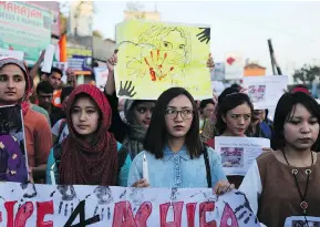  ?? CHANNI ANAND / THE ASSOCIATED PRESS ?? Students participat­e in a candleligh­t procession Friday in Jammu, India, in protest against the rape and murder of an eight-year-old girl.