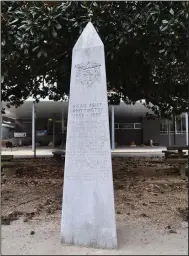  ?? Democrat-Gazette/Sonny Rhodes) ?? Directly north of St. Mary of the Springs Catholic Church (seen in the background), an obelisk highlights the life of Hiram Whittingto­n, who donated the land where the church was erected. (Special to the