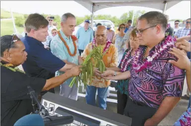  ?? The Maui News COLLEEN UECHI photo ?? Kahu Marcelo Bustillos (from left) carries out a blessing of the Lahaina bypass southern terminus Sunday afternoon alongside Len Dempsey, vice president for Hawaiian Dredging Constructi­on Co.’s Heavy Division; Peter Osborn, Federal Highway...