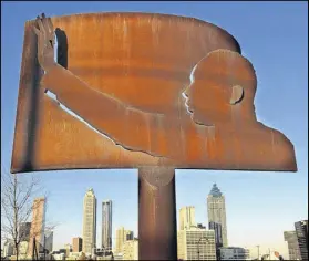  ?? AJC FILE ?? A sculpture of the Martin Luther King Jr. sits at the intersecti­on of Boulevard and Freedom Parkway.