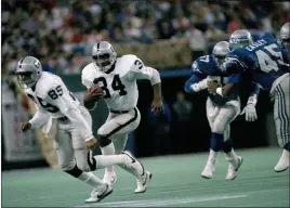  ?? Barry Sweet The Associated Press ?? Bo Jackson (34) became a legend in his 235-total yard, three-touchdown game against Seattle on Monday Night football that included a collision with Brian Bosworth.