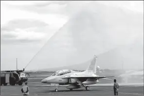  ?? AP/BULLIT MARQUEZ ?? Philippine officials welcome their new FA-50 fighter jets with a water cannon salute Saturday as the planes arrive at Clark Air Base north of Manila.