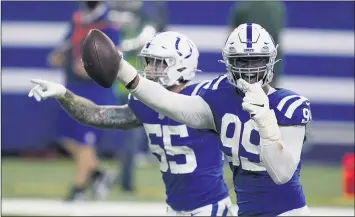  ?? MICHAEL CONROY/AP ?? The Colts' DeForest Buckner (99) celebrates recovering a fumble during the overtime of an NFL football game against the Green Bay Packers, Sunday, Nov. 22, 2020, in Indianapol­is. (AP Photo/Michael Conroy)