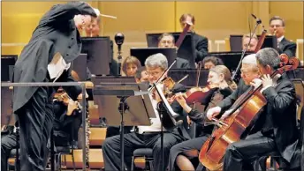  ??  ?? Sir Gilbert Levine conducts “Peace Through Music — in The Spirit of John Paul-chicago 2012” at Orchestra Hall. | KAREN CALLAWAY~CATHOLIC NEW WORLD