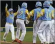  ?? GENE J. PUSKAR — ASSOCIATED PRESS ?? Honolulu’s Sean Yamaguchi, left, is greeted by teammates after hitting a grand slam in the team’s 10-0 win over Staten Island in South Williamspo­rt, Pa., on Wednesday.