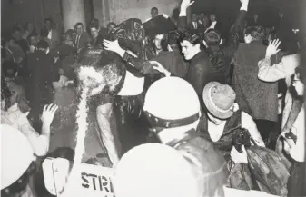  ?? Bob Campbell / The Chronicle 1960 ?? Police use a fire hose on people protesting hearings of the House Un-American Activities Committee at San Francisco City Hall. The protesters had been singing “We Shall Not Be Moved.”