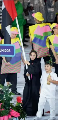  ?? AFP file ?? keeping THe flag flying: UAE’s flagbearer swimmer Nada Albedwawi leads the delegation during the opening ceremony of the Rio 2016 Olympic Games at the Maracana Stadium in Rio de Janeiro. She competed in the women’s 50 metre freestyle event. —