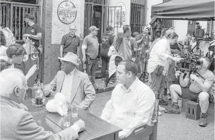  ?? Desmond Boylan photos / Associated Press ?? A “House of Lies” filming crew prepares the set outside the Bodeguita Del Medio bar during a shoot, in Havana, Cuba. American producers are thrilled to be able to use thousands of colonial and Art Deco buildings as backdrops,