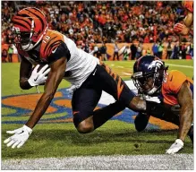  ?? DAVID ZALUBOWSKI / AP ?? Bengals receiver A.J. Green beats Broncos cornerback Bradley Roby for an 18-yard TD catch to give the Bengals a 20-10 lead in the fourth quarter. Green had four catches for 50 yards.