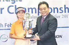  ??  ?? Angel receiving her trophy from Enagic Malaysia Sdn Bhd country manager Nick Nakao.
