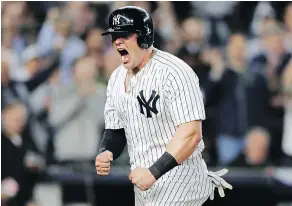  ?? — GETTY IMAGES ?? Luke Voit celebrates after scoring a run at home plate during the New York Yankees’ 7-2 win over the Oakland Athletics Wednesday in the American League Wild Card Game in the Bronx.