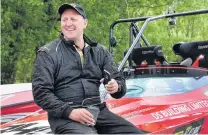  ??  ?? Taking a break . . . Dairy farmer Greg Wilson, of Wangaloa, near Balclutha, relaxes between legs of the Waitaki River raceday during the NZ jetboat river racing championsh­ips.