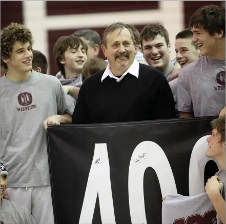  ?? NATE HECKENBERG­ER — FOR MEDIANEWS GROUP ?? Oxford wrestling coach Scott Gold is honored after a milestone win. For 49years, Gold led the Hornets, as one of just three coaches the school has ever known.