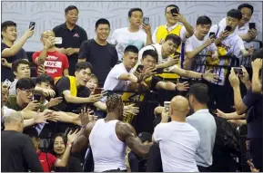  ?? COLOR CHINA PHOTO VIA AP ?? Fans take pictures of the Lakers’ Dwight Howard at the NBA China Games 2019in Shenzhen saturday.