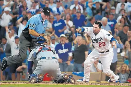  ?? Robert Gauthier Los Angeles Times ?? ADRIAN GONZALEZ of the Dodgers touches home plate with his left hand as Willson Contreras of the Cubs applies the tag in the second inning. Umpire Angel Hernandez ruled Gonzalez out and a nearly three-minute review in New York upheld the decision.